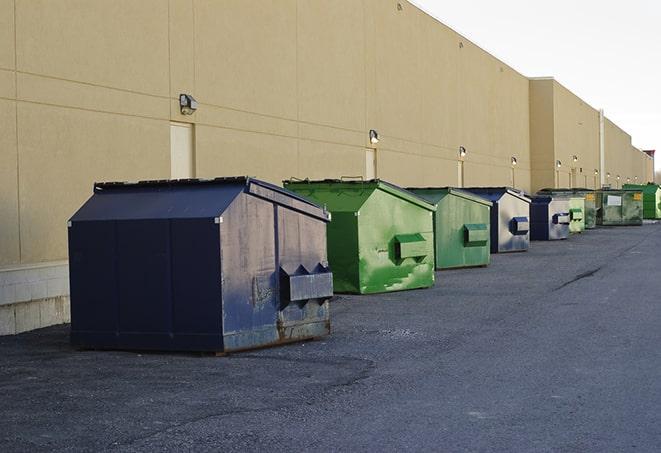 an assortment of sturdy and reliable waste containers near a construction area in Davison